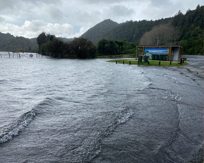 Water overflowing from a lake beside a road